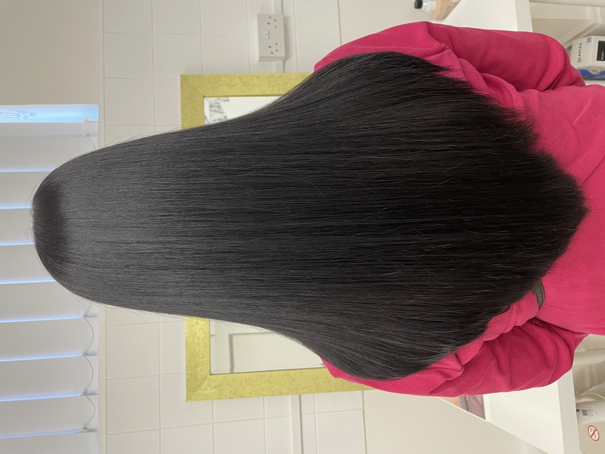 Long black hair cut to a soft V shape, straightened and glossy